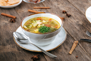 Sticker - Bowl of vegetable soup with chicken on the wooden table