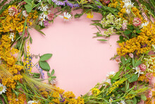 Beautiful Wreath Of Wild Flowers , Typical Scandinavian Midsummer Decoration Concept. Pink Background. Top View
