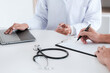 Doctor with patient consultation in medical office. Visiting Physician concept