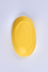 Wall Mural - Top view of yellow soap bar isolated on white background.