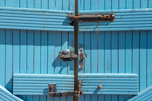 Three Old Rusty Locks On Blue Gate 