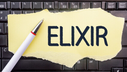 Elixir Programming Language. Word Elixir on paper and laptop 