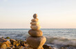 © scullery - Balanced stones on the seashore summertime and sea background