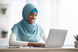 © Prostock-studio - Portrait Of Black Islamic Woman In Hijab Working On Laptop In Office