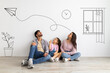 © Prostock-studio - Lovely child girl and her young parents dreaming about their new home with sketch interior drawings against white wall