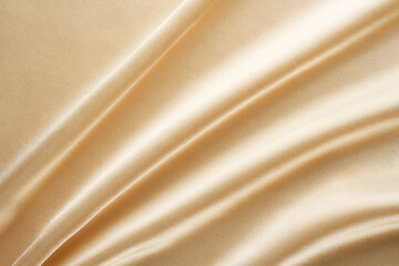 Wall Mural - shiny light golden fabric draped with large folds, textile background