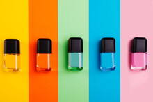 Group Of Vivid Color Nail Polishes Isolated On Colorful Background