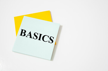 BASIC text written on a white notepad with colored pencils and a yellow background. word