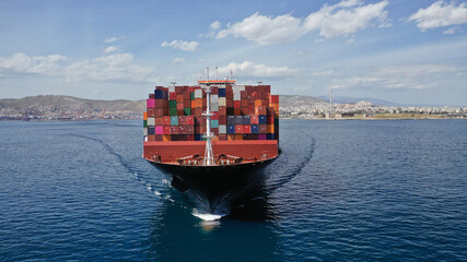 Wall Mural - Aerial drone photo of huge container carrier tanker ship cruising deep blue open ocean sea