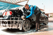 © Ruslan Ivantsov - The man washing his car on self-service car wash. Express Car Wash