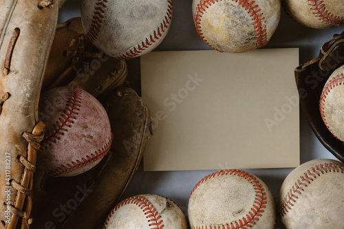 old used baseball balls and glove with copy space on card in background.