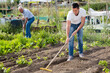 © JackF - Elderly father and adult son work in the garden. High quality photo