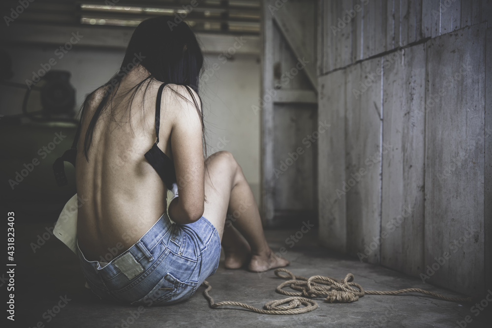 The back of the girl After being raped, The concept of sexual harassment against women and rape, sexual abuse, human trafficking, domestic, international women's day. - obrazy, fototapety, plakaty 