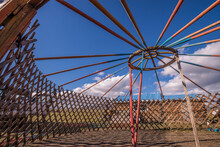 Mongolian Yurt (ger) Frame Being Erected Against Blue Skies