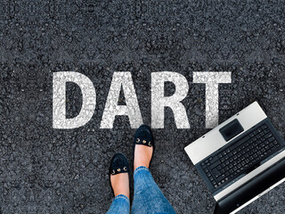 dart programming language. legs in sneakers standing next to laptop and word dart