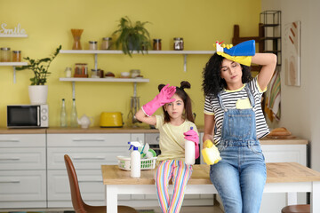 Sticker - Mother and daughter resting after cleaning table in kitchen