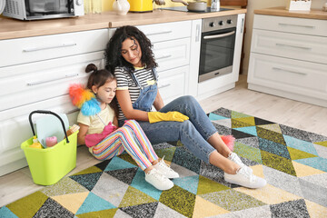 Poster - Mother and daughter resting after cleaning their kitchen