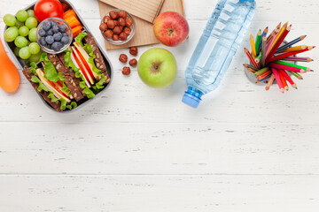 Healthy school lunch box with sandwich and fresh vegetables