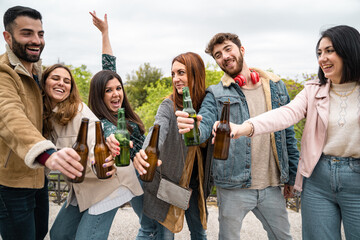 Wall Mural - Millennials people having fun drinking beers and joking together. 