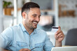 © Dragana Gordic - Online shopping. Young handsome man shopping online with credit card and laptop at home. Making some quick payments online. Shot of a young man using a laptop and credit card at home