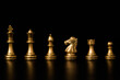 Golden chess include king queen horse ship and pawn on black background.