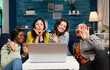 © DC Studio - Cheerful multi ethnic friends waving at camera during online internet video call conference while having fun. Group of multiracial people spending time together sitting on couch