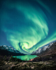 Wall Mural - Vertical shot of a night winter landscape with Northern lights reflection on the lake,Tromso