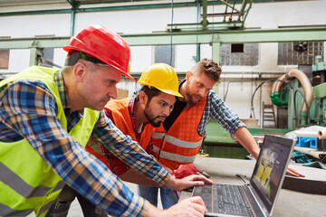 Group of craftsmen and workers on laptop computer