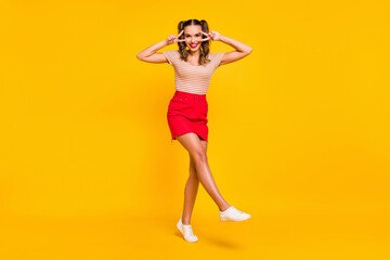 Sticker - Full length photo of lady dance show v-sign wear striped shirt short skirt footwear isolated yellow color background