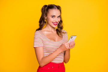 Sticker - Portrait of attractive cheerful girl using gadget browsing multimedia comment isolated over bright yellow color background