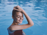 Fototapeta Abstrakcje - smiling woman with closed eyes Swimming in the pool rest close-up