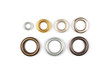 Catalogue photo of different brass multicoloured metal eyelets or rivets - curtains rings for fastening fabric to the cornice, isolated on white background with copyspace for text. Selective focus