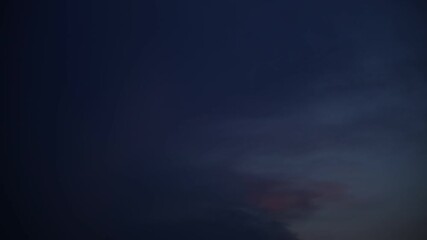 Wall Mural - Clouds move in the sky at dusk.