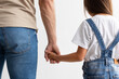 © Prostock-studio - Closeup of father and daughter holding hands