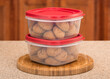 © Kevin Brine - Freshly baked molasses cookies sealed in plastic food containers on kitchen countertop.