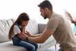 © Prostock-studio - Little girl crying, upset young father consoling daughter