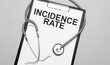 The words incidence rate is written on white paper on a grey background near a stethoscope. Medical concept