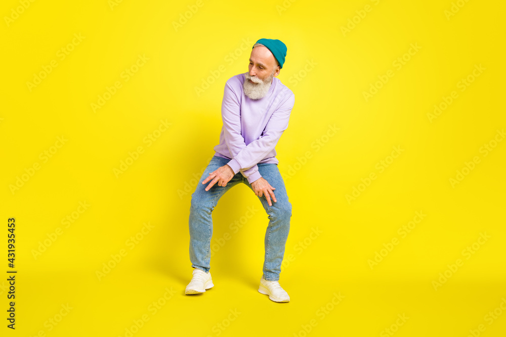 Photo of handsome attractive mature man dressed purple pullover headwear dancing smiling isolated yellow color background