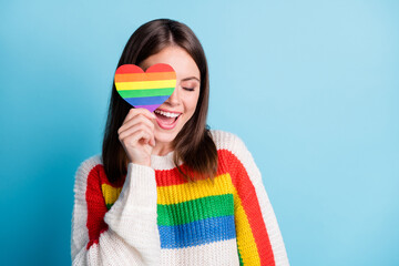 Sticker - Photo of dreamy sweet young woman dressed striped sweater cover eye colorful heart smiling empty space isolated blue color background