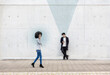 © Emma Innocenti/Westend61 - Graphic visualization of data sent by man and woman using smart phones outdoors
