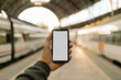 © Gerard Moral Casanovas/Westend61 - Young man photographing with smart phone at railroad station