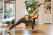 © Gerard Moral Casanovas/Westend61 - Woman practicing extended side angle pose on mat at home