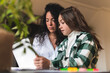 © Josu Acosta/Westend61 - Girl discussing with mother while e-learning through laptop at home