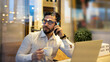 © Jose Carlos Ichiro/Westend61 - Businessman talking on smart phone while holding coffee cup in cafe