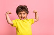 © shara - Funny little sportive kid boy in yellow shirt, showing his muscles. Happy strong nerd kindergarten child showing bicep. Dream, confidence, success, possible, innovation. Go back elementary school.
