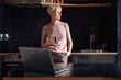 © Robijn Page/Westend61 - Female entrepreneur with hands in pockets looking away while having coffee in kitchen in home office