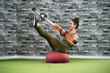 © Mikel Taboada/Westend61 - Happy sportswoman exercising on balance trainer with liquid tube at health club