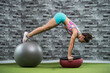 © Mikel Taboada/Westend61 - Active female athlete exercising with fitness ball in gym