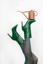 Mature Woman Green Boots With Kettle Against White Background
