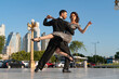 © Spectral/Westend61 - Confident male and female dancers practicing on footpath against blue sky